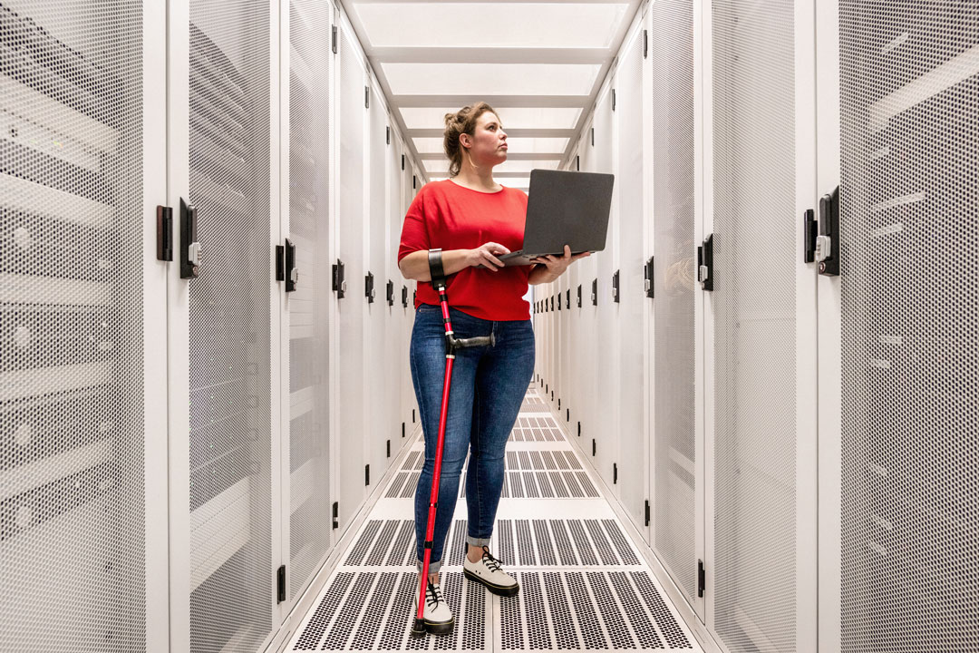 Woman with a damaged hip joint working in data centre Woman with a damaged hip joint working in data centre
