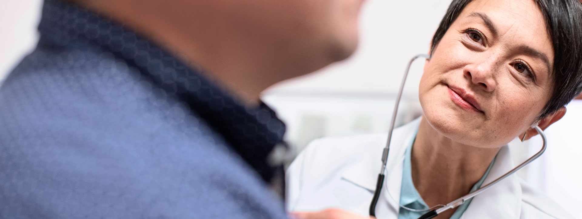 child looking at ipad with doctor