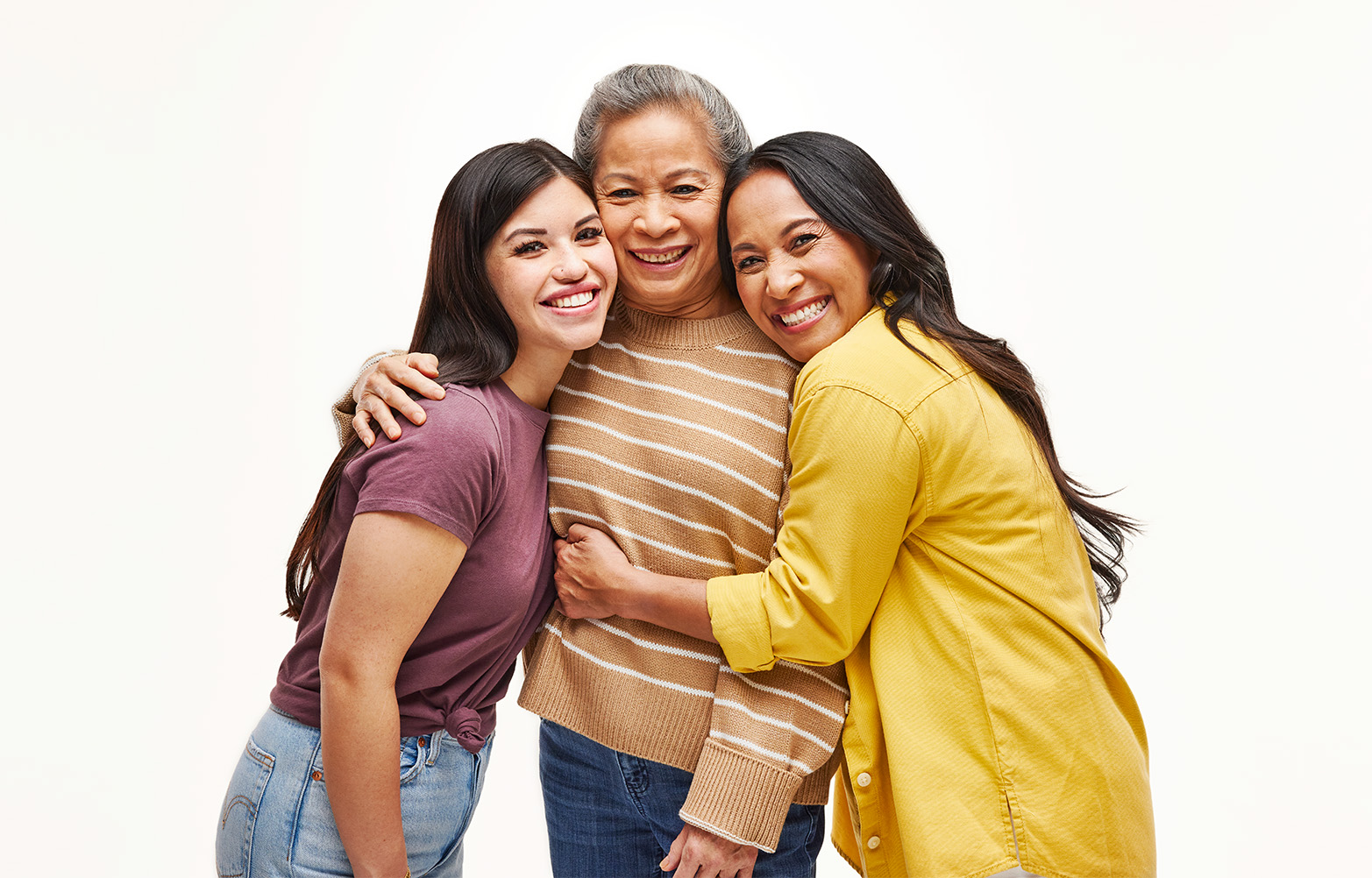 Three generations of a family, all female-presenting people, hugging.