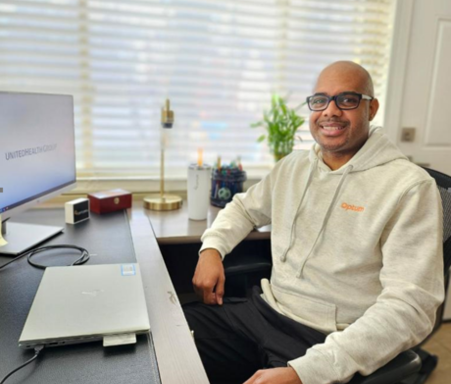 man sitting in a chair at a desk