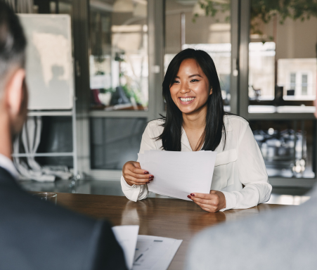 women sitting at desk with paper